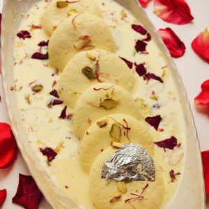 Creamy rasmalai topped with saffron strands and crushed pistachios in Cambridge, Ma