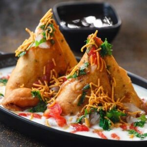 Samosa topped with chaat ingredients in Cambridge, Ma