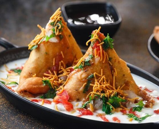 Samosa topped with chaat ingredients in Cambridge, Ma